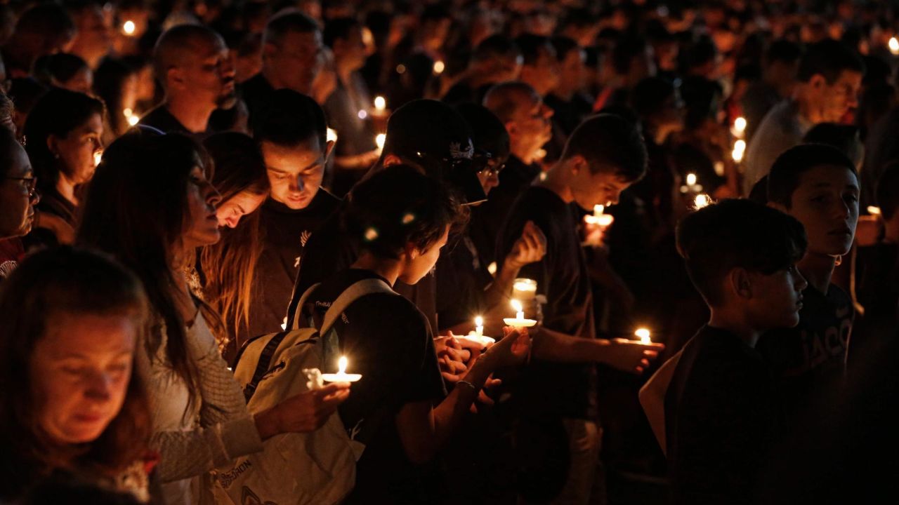 Thousands of mourners attend a candlelight vigil the day after the shooting at Marjory Stoneman Douglas High School shooting in Parkland, Florida.