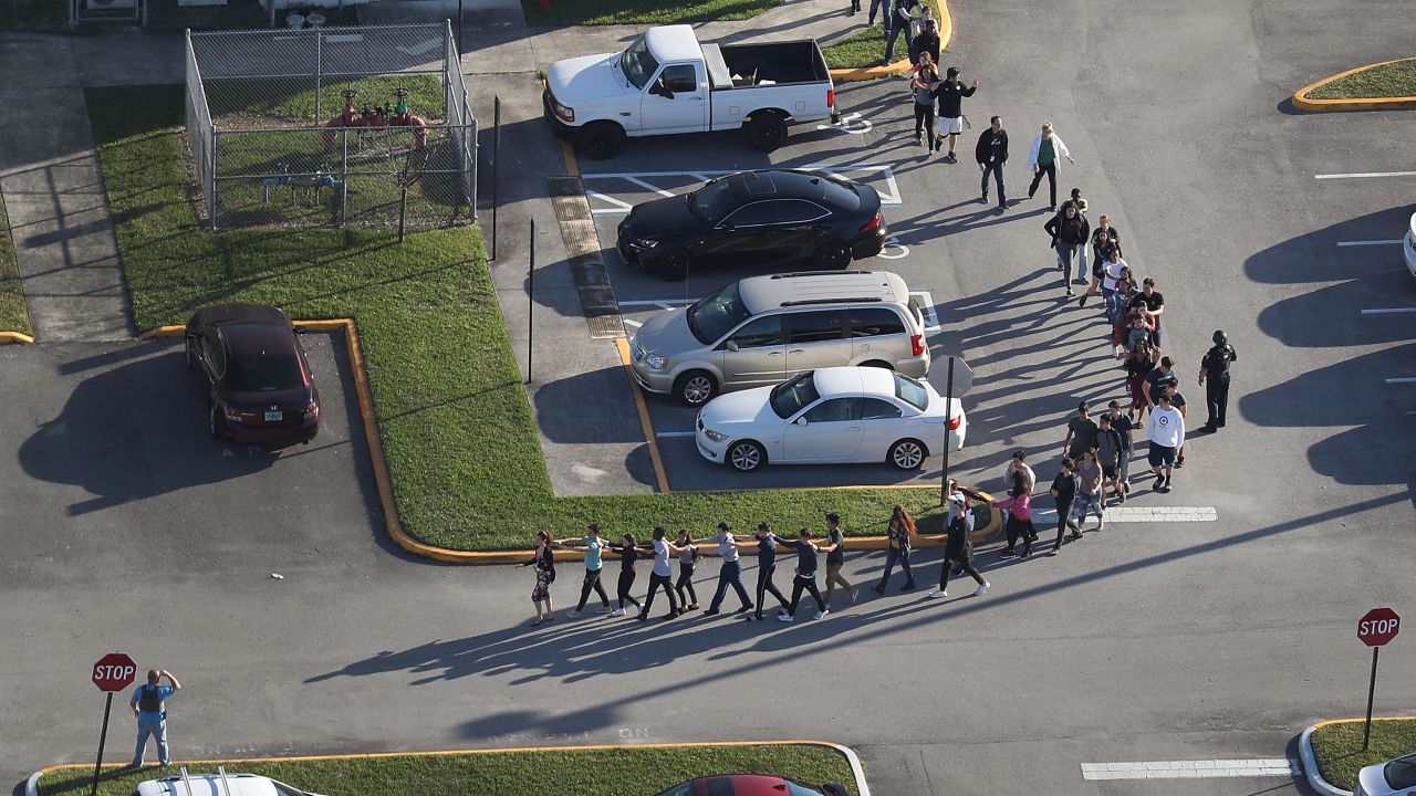 PARKLAND, FL - FEBRUARY 14:  People are brought out of the Marjory Stoneman Douglas High School after a shooting at the school that reportedly killed and injured multiple people on February 14, 2018 in Parkland, Florida. Numerous law enforcement officials continue to investigate the scene.  (Photo by Joe Raedle/Getty Images)