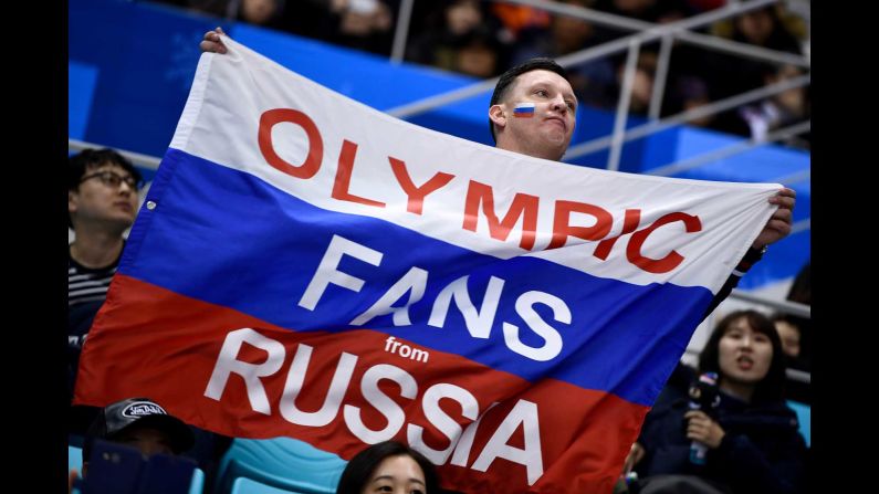 A fan attends the men's hockey game between Slovenia and the Olympic athletes from Russia.