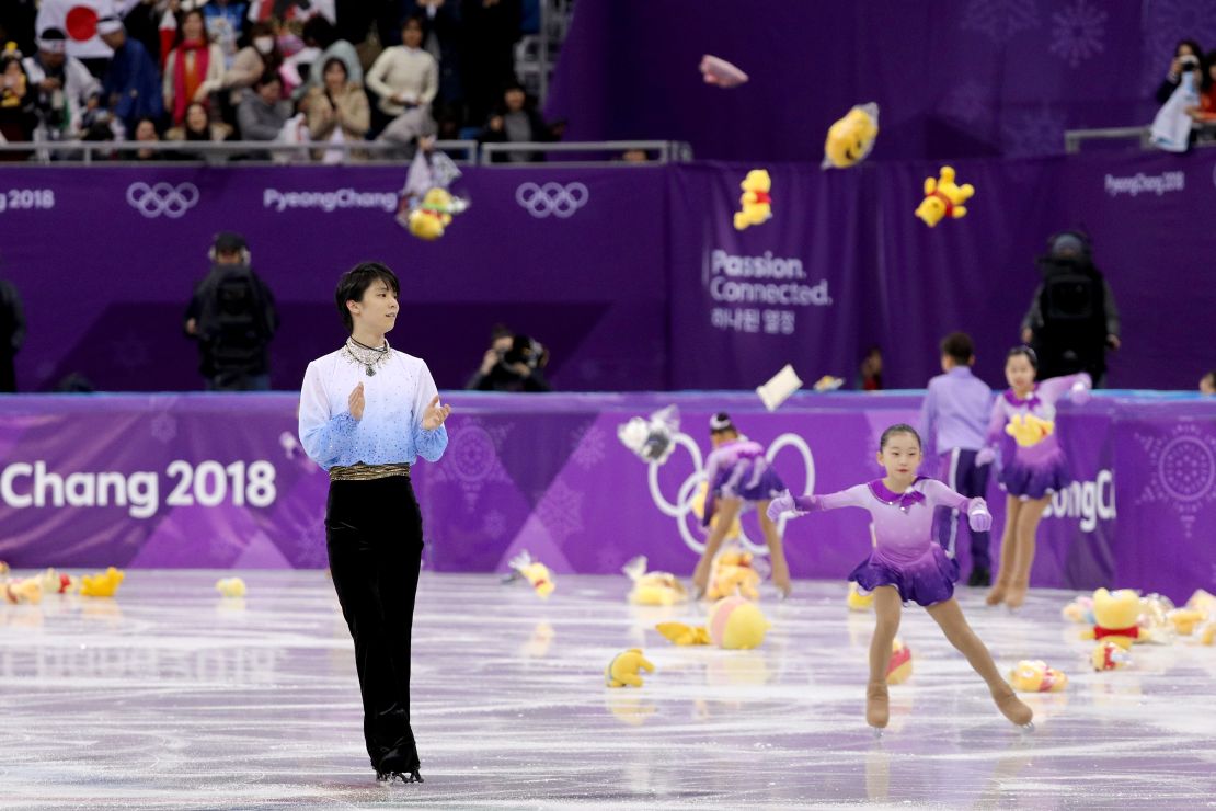 Fans throw gifts on to the ice for Yuzuru Hanyu after his routine during the men's short program at Gangneung Ice Arena.