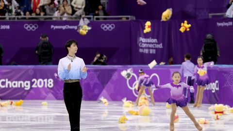 Fans throw gifts on to the ice for Yuzuru Hanyu after his routine during the men's short program at Gangneung Ice Arena.