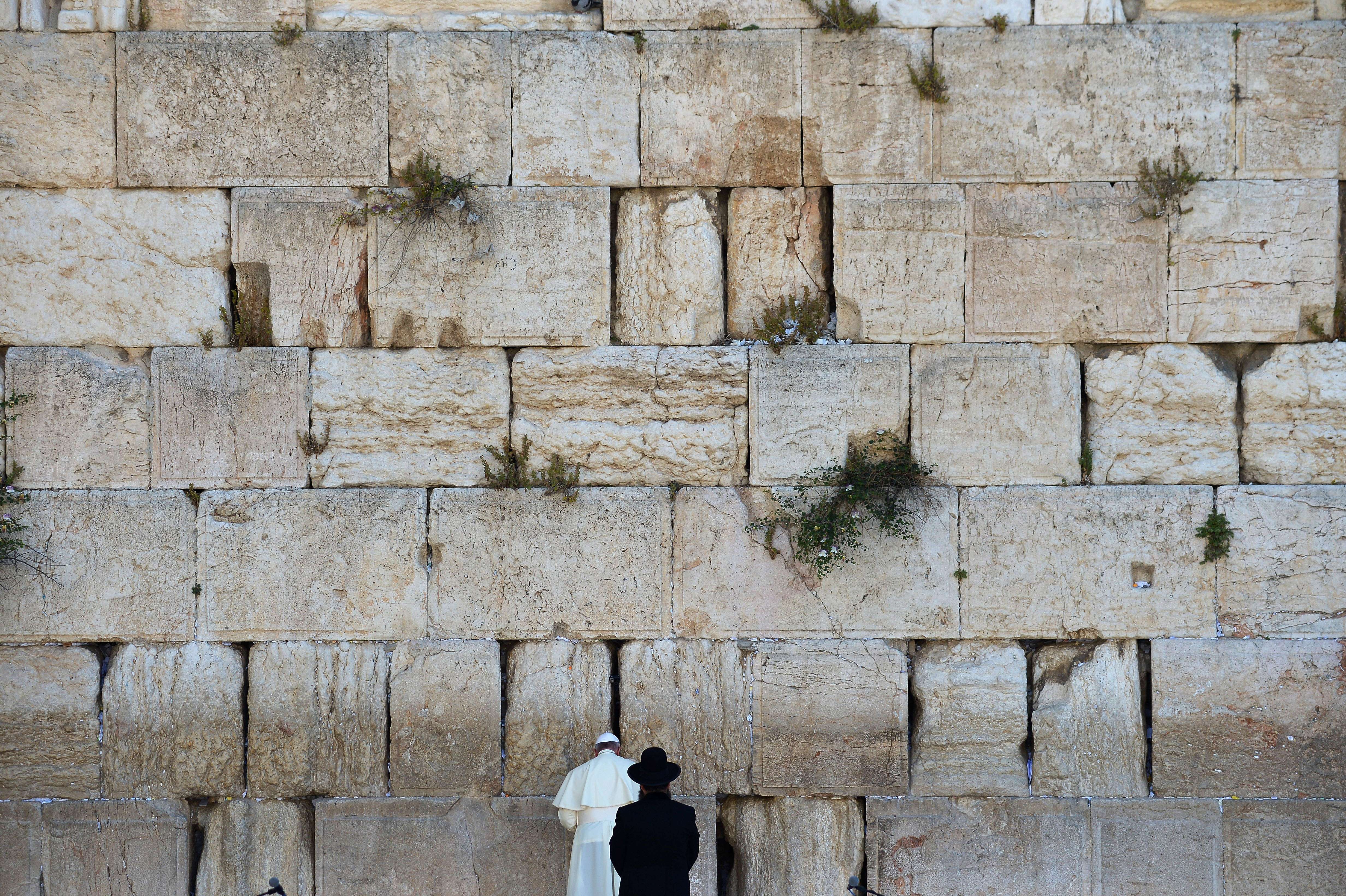 Francis prays next to a rabbi at the Western Wall in Jerusalem's Old City in May 2014.