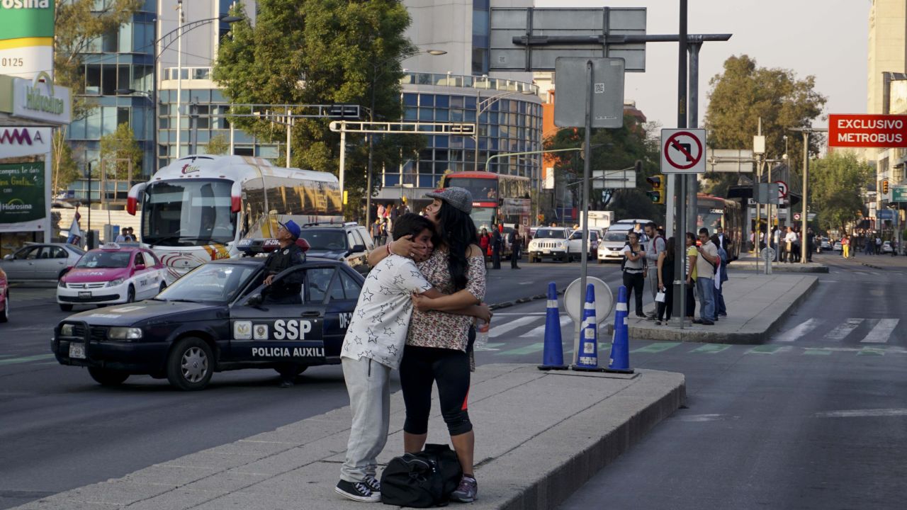 A woman embraces a boy after an earthquake shook buildings in Mexico City.