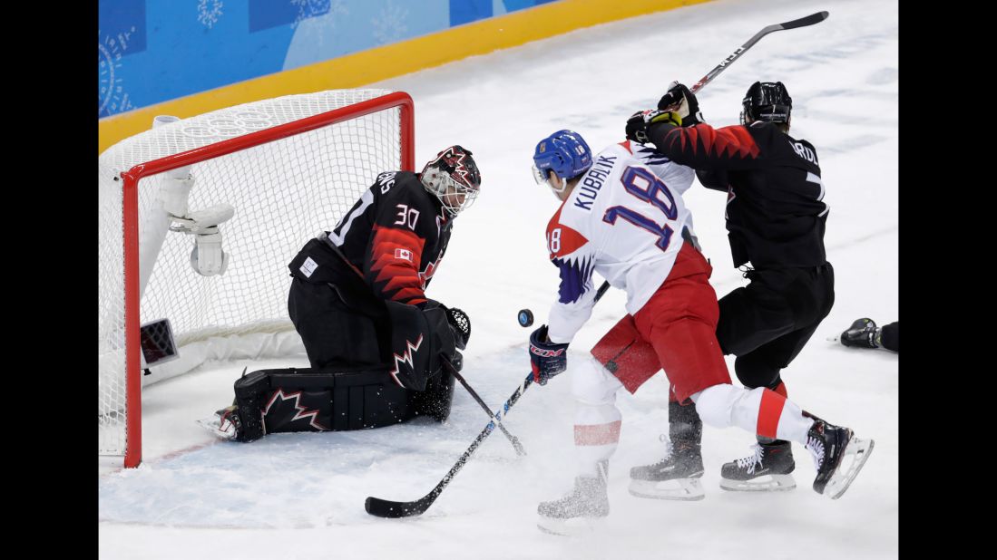 Dominik Kubalik of the Czech Republic shoots the puck against Canada's Ben Scrivens during a preliminary round hockey game.
