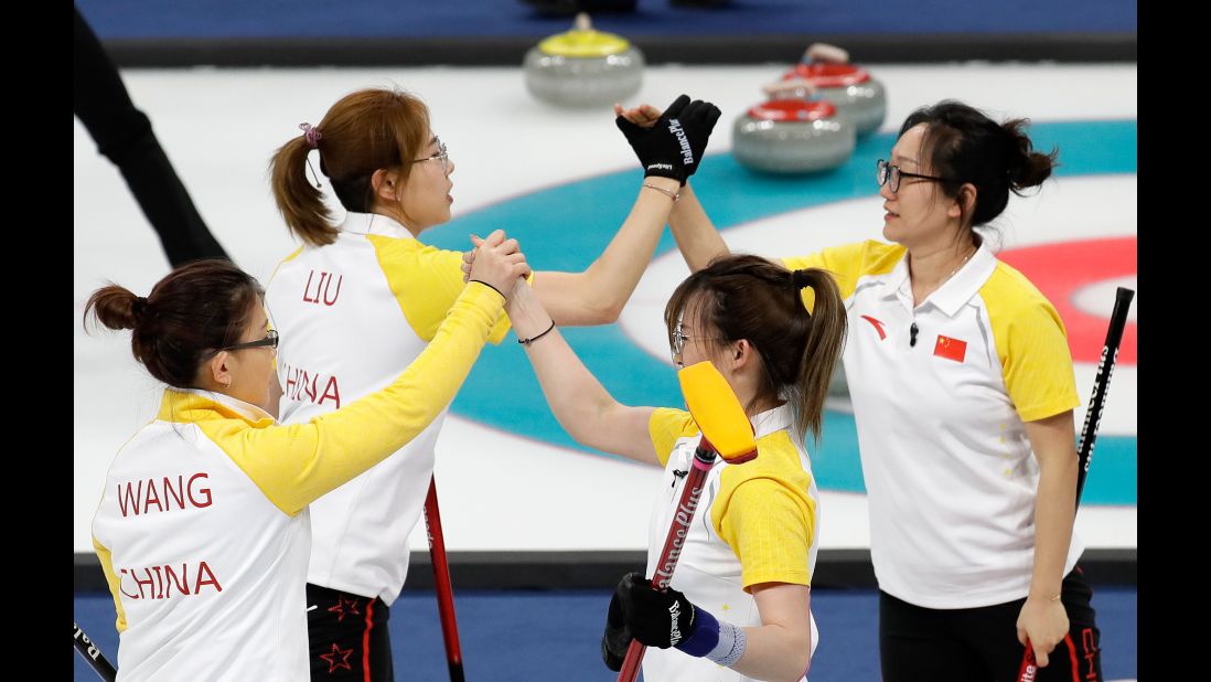 The women's curling team from China celebrates after a win over Japan.