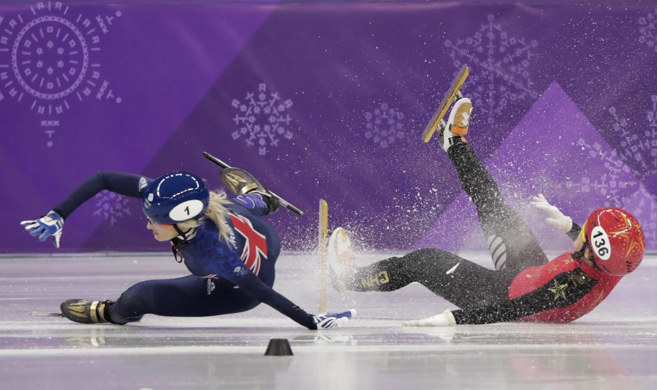 Great Britain's Elise Christie, left, and China's Li Jinyu crash during a short-track semifinal for the 1,500 meters. Christie was taken off the ice on a stretcher.