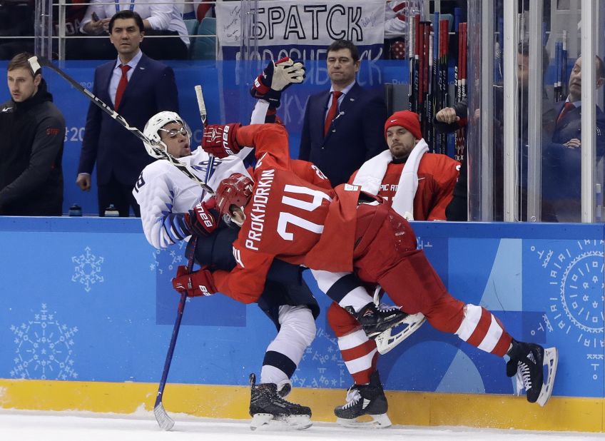 American Jordan Greenway gets checked by Russian Nikolai Prokhorkin during the preliminary round of play. The Olympic Athletes from Russia imposed their will in a 4-0 men's hockey win over the United States.