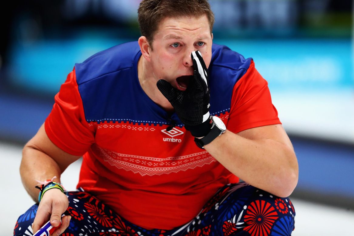 Christoffer Svae of Norway gives instructions to a team member during a curling round-robin session.