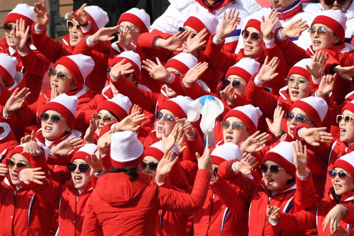 North Korean cheerleaders sing and wave during the men's giant slalom.