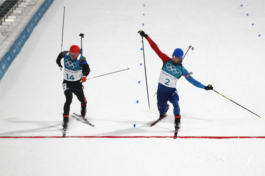 France's Martin Fourcade, right, barely beats Germany's Simon Schempp to the finish line to win gold in the mass-start biathlon.