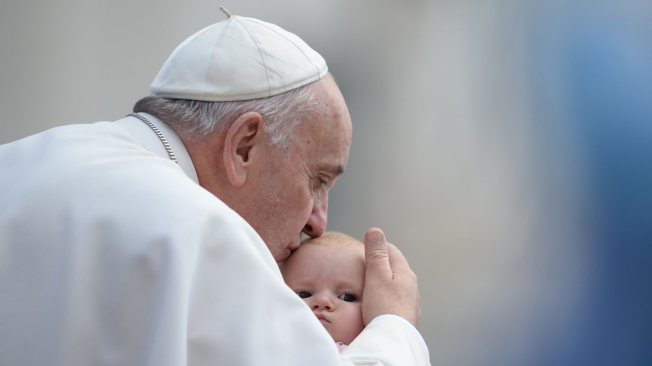 The Pope kisses a baby at the Vatican in October 2015.