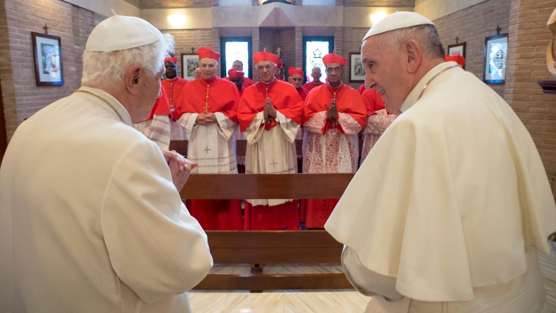 Francis and a group of cardinals meet with Pope Emeritus Benedict XVI in a chapel at the Vatican in November 2016.