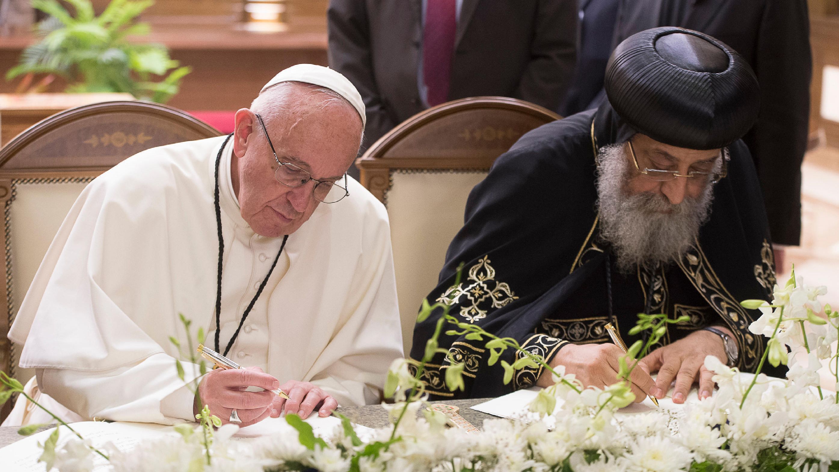 Francis and Pope Tawadros II, the head of Egypt's Coptic Orthodox Church, sign a joint declaration in Cairo in April 2017.