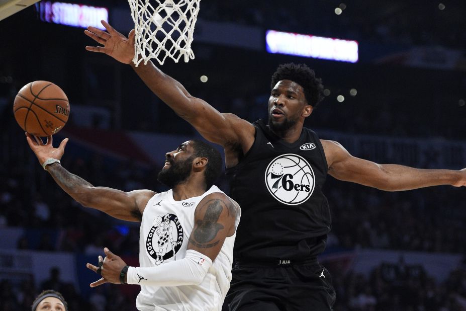 Irving, playing for Team LeBron, is defended by Joel Embiid during the first half. It was the first time Irving played with James since being traded by the Cleveland Cavaliers.