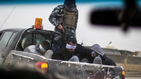 Christian militia fighters from the Nineveh Plain Protection Units (NPU) drive a pick-up truck in Qaraqosh (also known as Hamdaniya), transporting four men, allegedly members of the Islamic State (IS) group that were found inside a tunnel in Mosul.