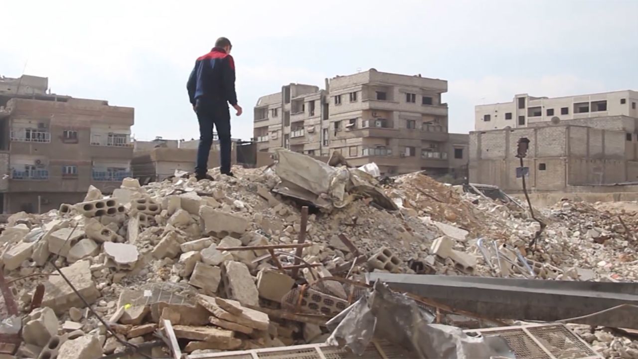 Najem surveys the damage in his neighborhood.
