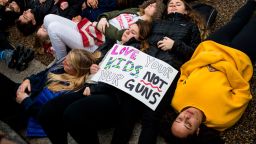 WASHINGTON, DC - FEBRUARY 19: Demonstrators lie on the ground during a "lie-in" demonstration supporting gun control reform near the White House on February 19, 2018 in Washington, DC. According to a statement from the White House, "the President is supportive of efforts to improve the Federal background check system.", in the wake of last weeks shooting at a high school in Parkland, Florida. (Photo by Zach Gibson/Getty Images)