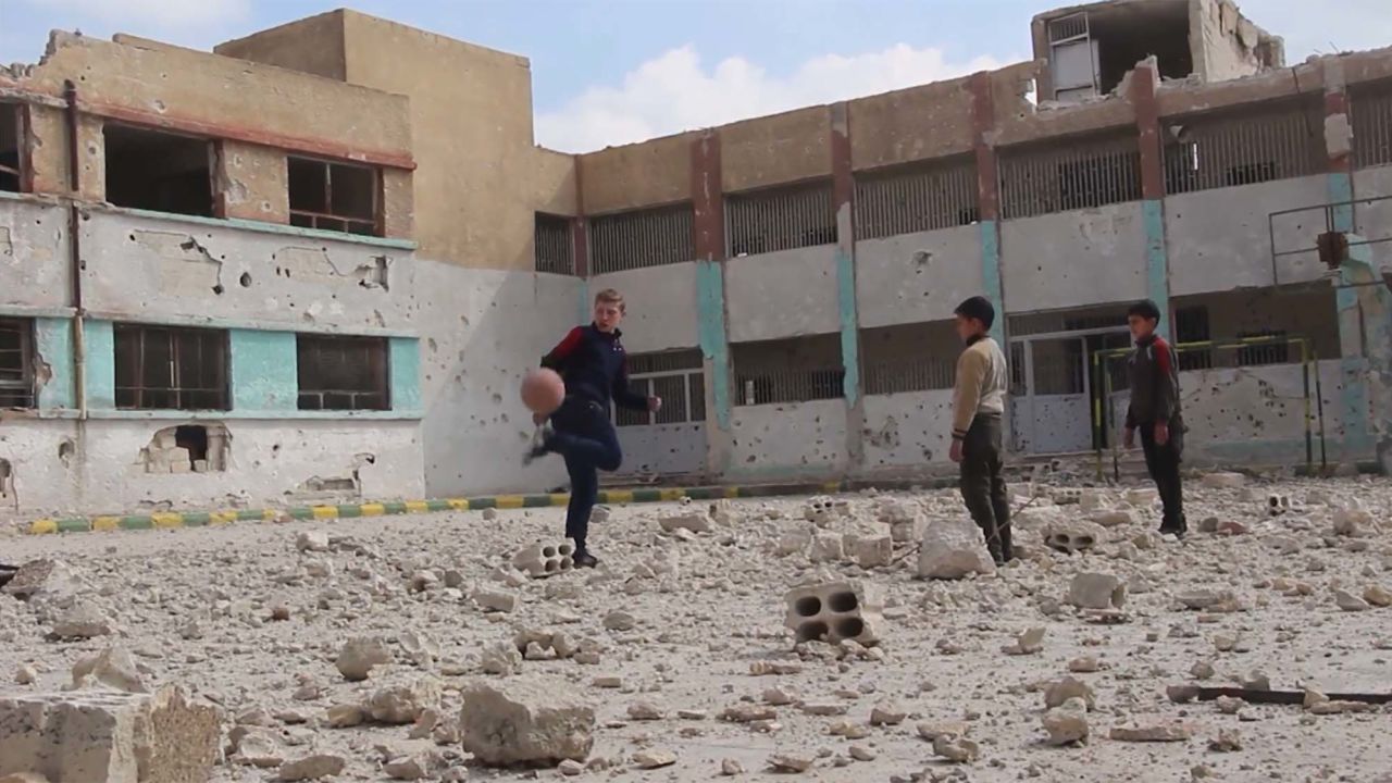 Najem plays soccer with his friends.