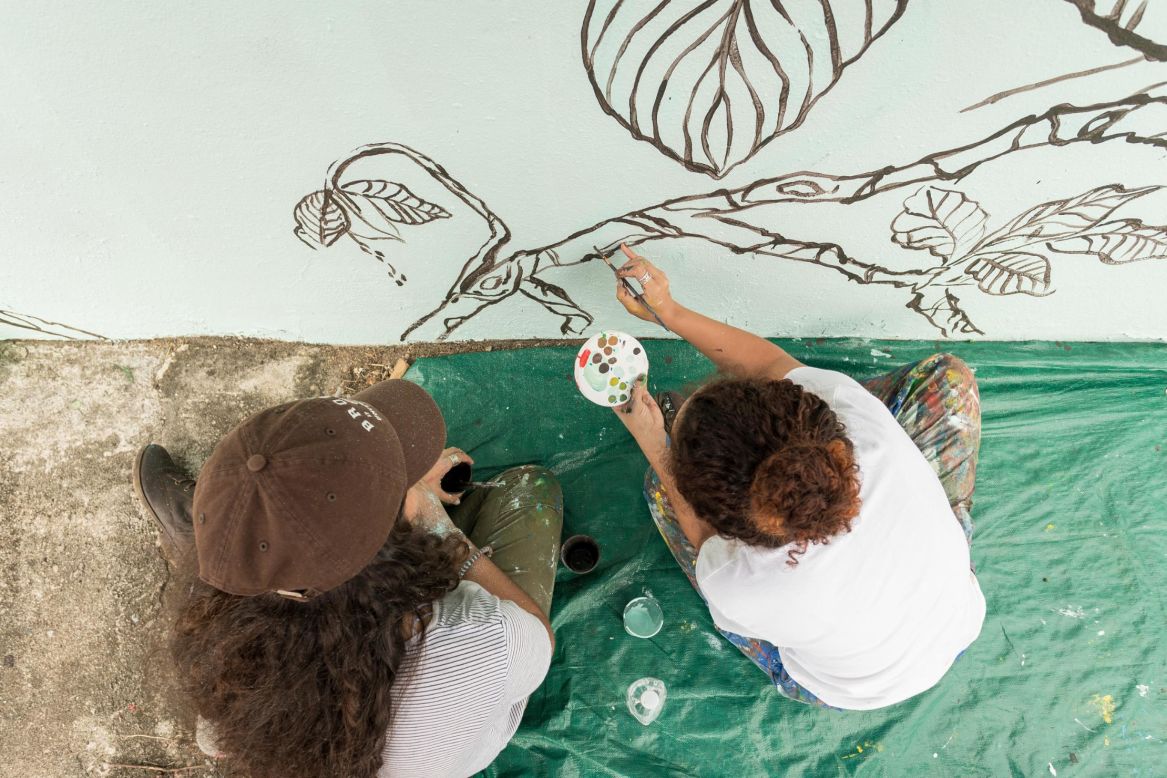 Residents of Punta Santiago, Puerto Rico, outline the foliage for the mural.