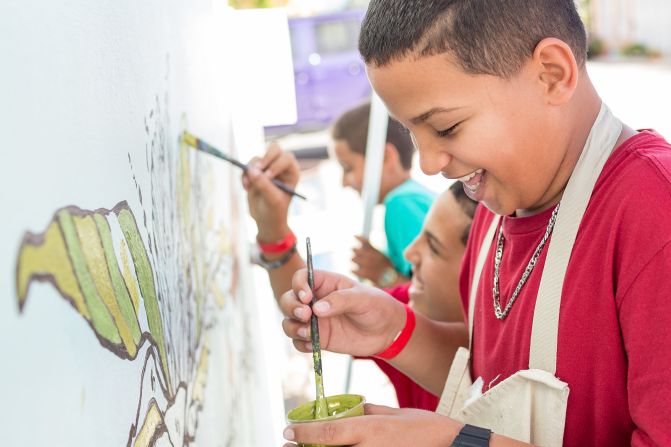 Children in Punta Santiago add color to the plants in the new mural.