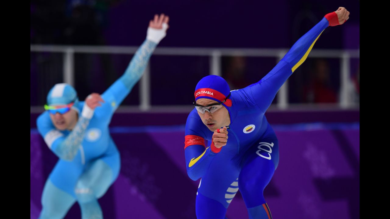 Colombian speedskater Pedro Causil, right, competes in the 500 meters.