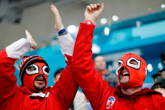 Canadian fans cheer during a men's curling match against Japan.