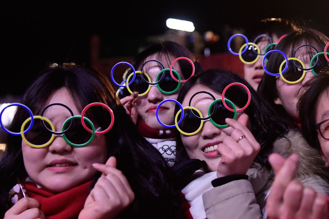 South Korean fans wearing sunglasses shaped like the Olympic rings attend medal ceremonies at the Pyeongchang Medals Plaza.