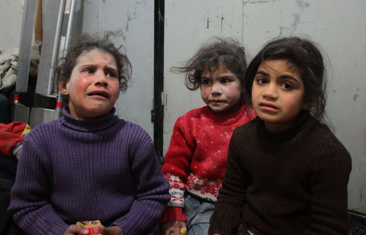 Children cry at a makeshift hospital in Douma.