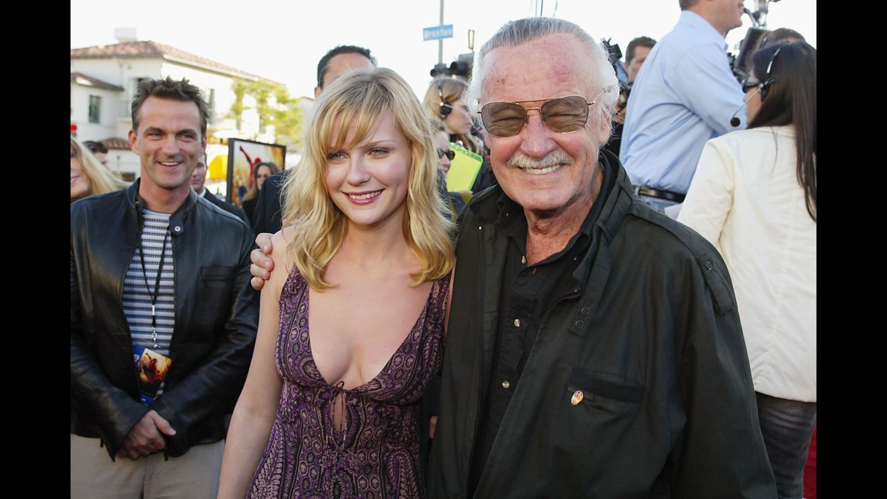 Lee arrives with actress Kirsten Dunst for the premiere of the film "Spider-Man" in 2002. Dunst played Mary Jane Watson in the film.