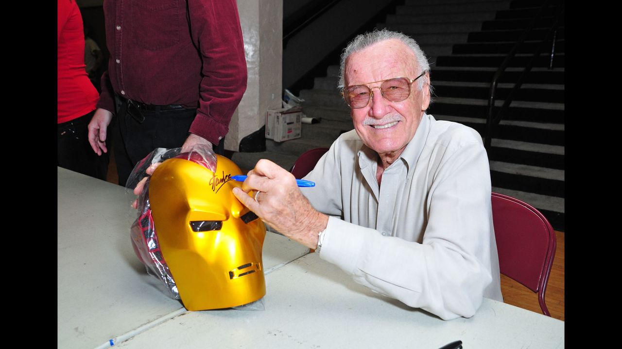 Lee signs an "Iron Man" mask in 2008.