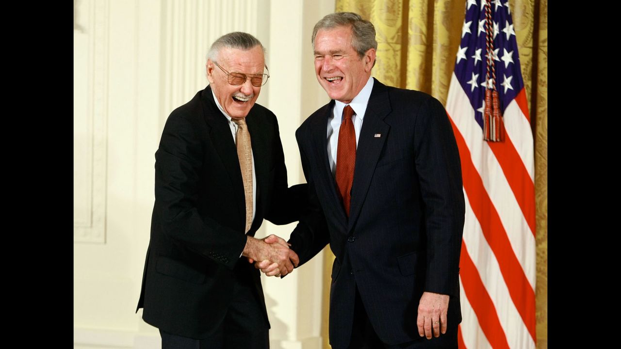 Lee shakes hands with US President George W. Bush after receiving a National Medal of Arts in 2008.
