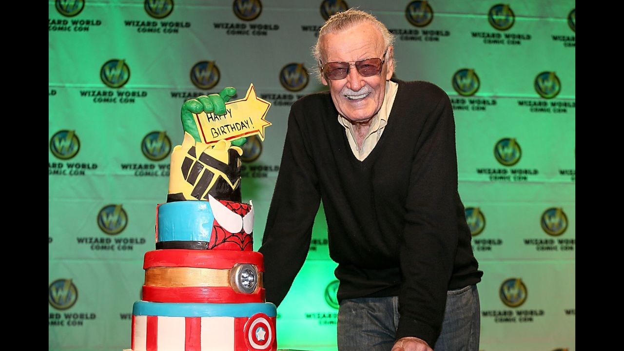 Lee is presented with a birthday cake for his 91st birthday in 2013.
