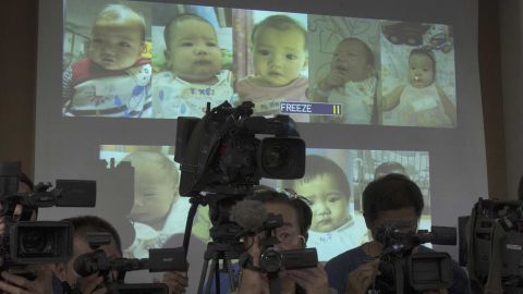 Thai police display projected pictures of surrogate babies born to a Japanese man at a press conference in 2014.