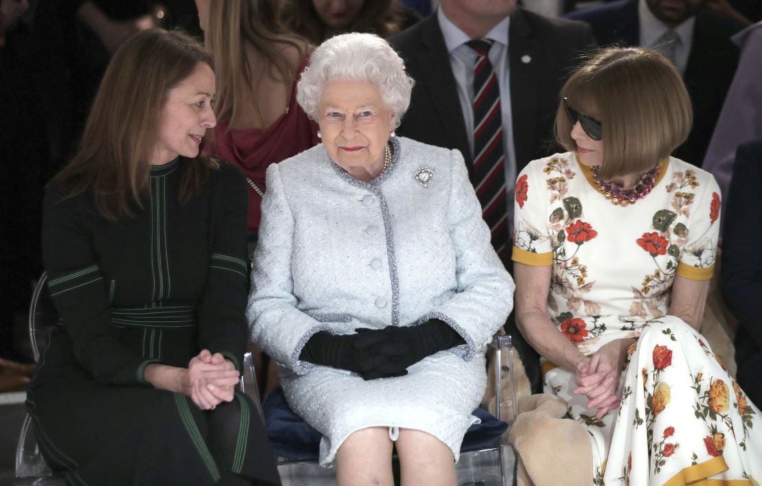 The Queen sits between Anna Wintour, right, and Caroline Rush, chief executive of the British Fashion Council (BFC) at Richard Quinn's runway show.