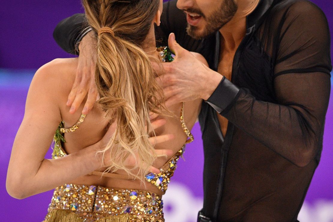 France's Guillaume Cizeron performs with France's Gabriella Papadakis as the back fastening of her costume is undone during the Ice Dance short dance.