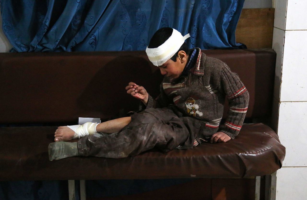 Ghaith, a wounded 12-year-old boy, cries as he waits for treatment -- and news of his mother in the operating room -- at a makeshift hospital in Kafr Batna. They were hurt in airstrikes on the town of Jisreen.