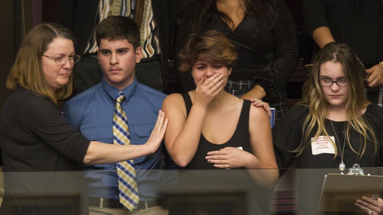 Sheryl Acquarola, a junior at Marjory Stoneman Douglas High School, is overcome with emotion in the east gallery of Florida's capitol after lawmakers voted not to hear a bill banning assault rifles and large capacity magazines. 
