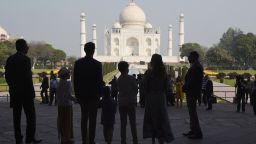 The Trudeau family stands silhouetted in front of the Taj Mahal in Agra.