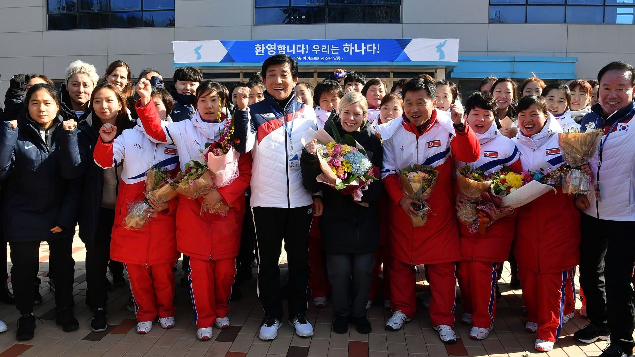 Coaches and players cheer during a welcoming ceremony.
