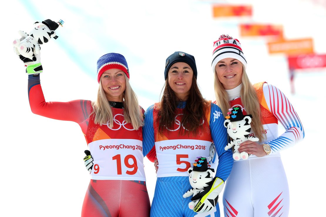 Gold medalist Sofia Goggia, center, of Italy celebrates with silver medalist Ragnhild Mowinckel, left, of Norway and bronze medalist Lindsey Vonn, right, of the United States during the victory ceremony for the Ladies' Downhill.