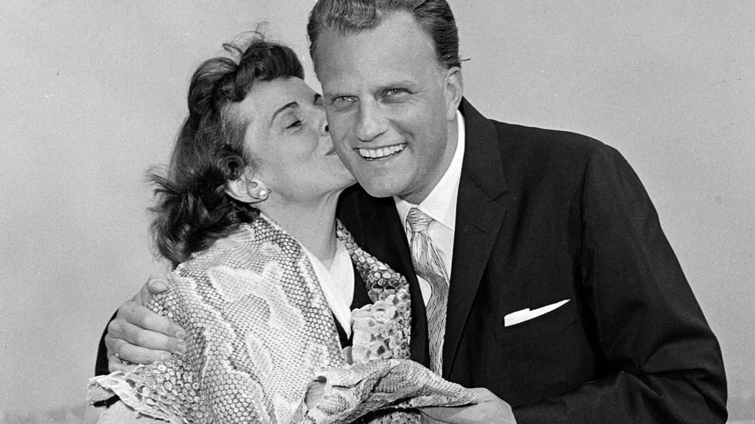 Graham gets a kiss from his wife, Ruth, after they returned to the United States following a tour in Africa and the Middle East.