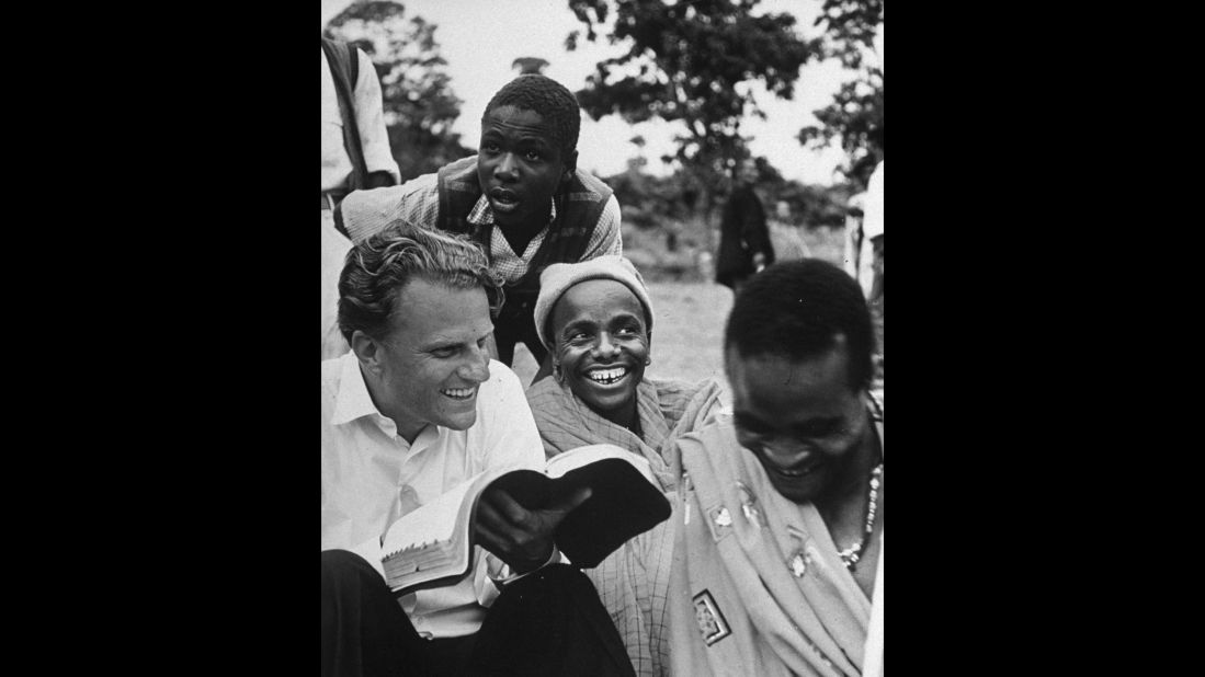 In 1960, Graham explains the Bible to Waarusha warriors in Tanzania.