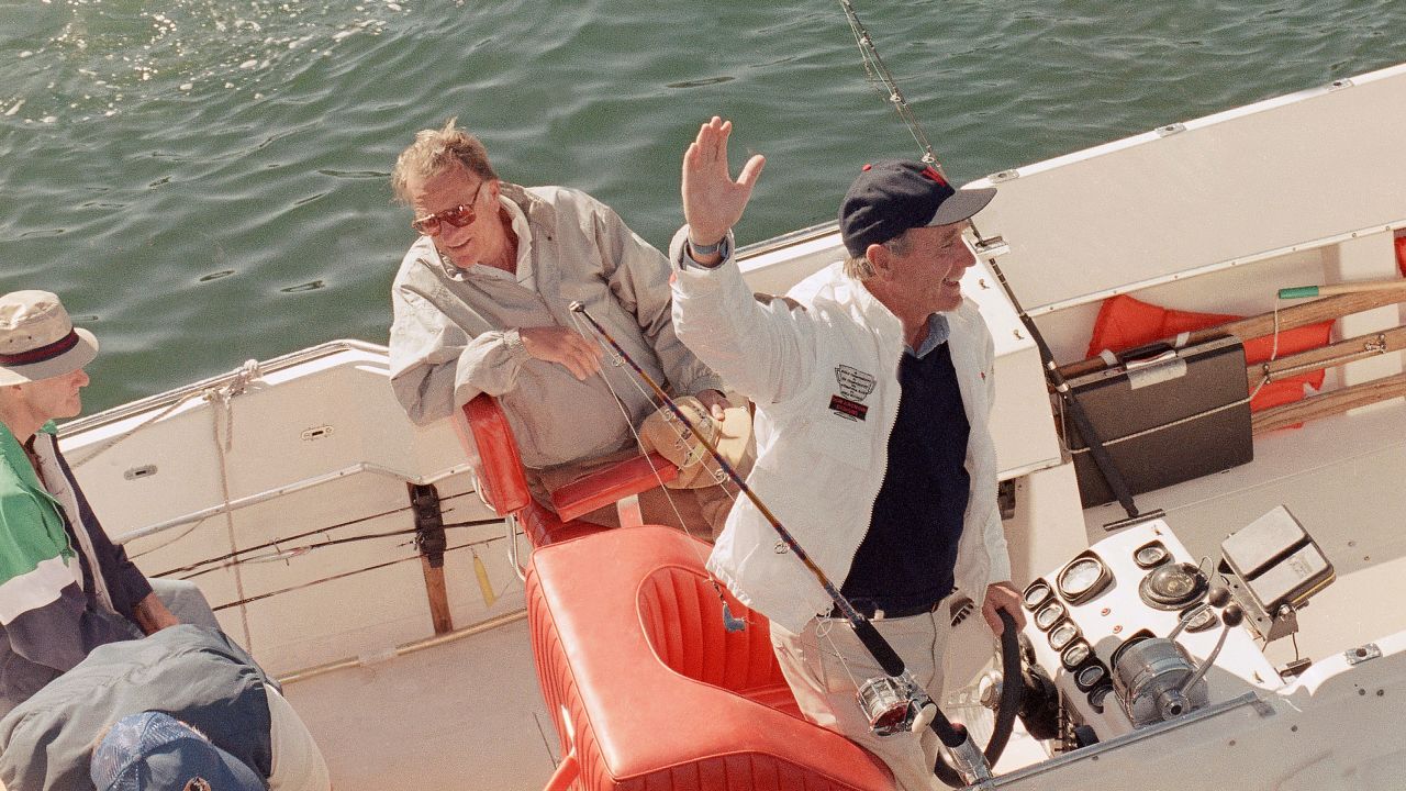 Graham takes a boat ride with US President George H.W, Bush near Bush's summer home in Kennebunkport, Maine, in 1989.