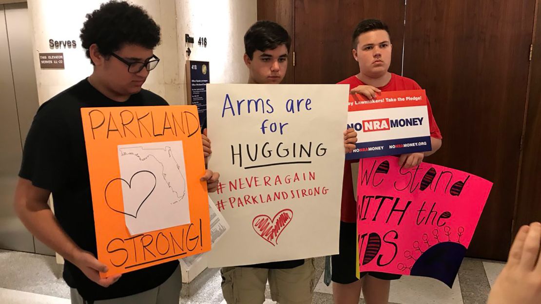 From left, Samuel Muster, 15, Zach Lesk, 16, and Zach Randoph, 15, show off the signs they took to lawmakers' offices. 