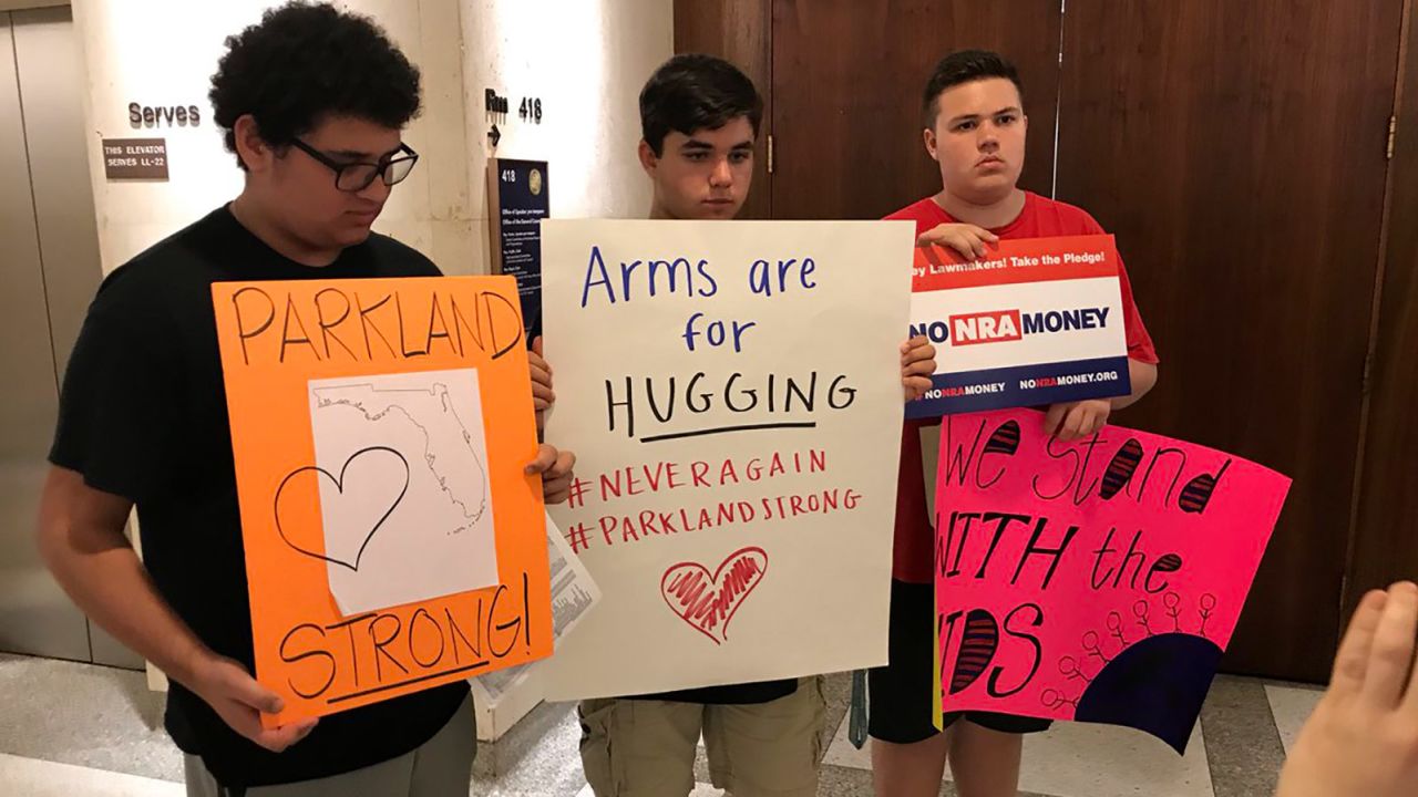 From left, Samuel Muster, 15, Zach Lesk, 16, and Zach Randoph, 15, show off the signs they took to lawmakers' offices. 