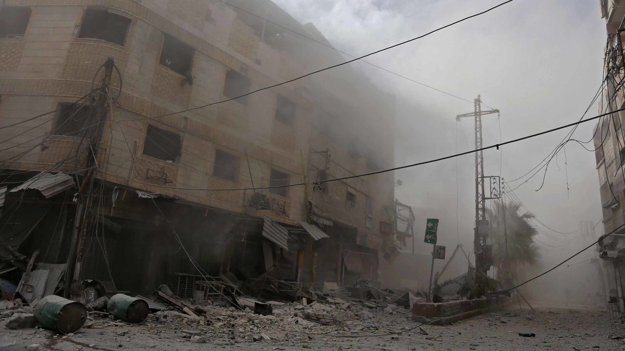 Smoke and dust are seen following a reported regime air strike in the rebel-held town of Hamouria, in the besieged Eastern Ghouta region on the outskirts of the capital Damascus on February 21, 2018.  / AFP PHOTO / ABDULMONAM EASSA        (Photo credit should read ABDULMONAM EASSA/AFP/Getty Images)