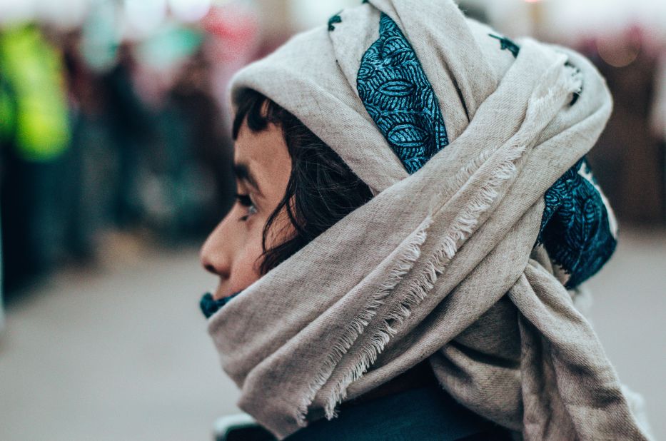 <strong>Family-friendly occasion: </strong>A young boy watches the proceedings at the camel festival while wearing a scarf to keep dust off his face.<br />