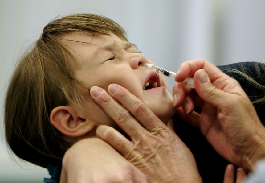 FILE- In this Oct. 4, 2005 file photo, a Danielle Holland reacts as she is given a FluMist influenza vaccination in St. Leonard, Md. On Wednesday, June 22, 2016, federal officials reported the latest in a growing series of study findings that show AstraZeneca's nasally-administered FluMist has not been working. (AP Photo/Chris Gardner, File)