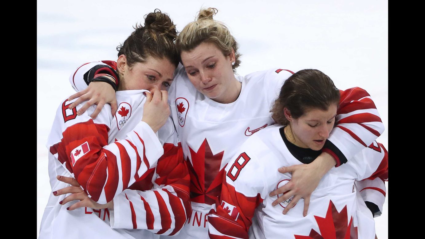 The Canadian players console themselves after their loss.