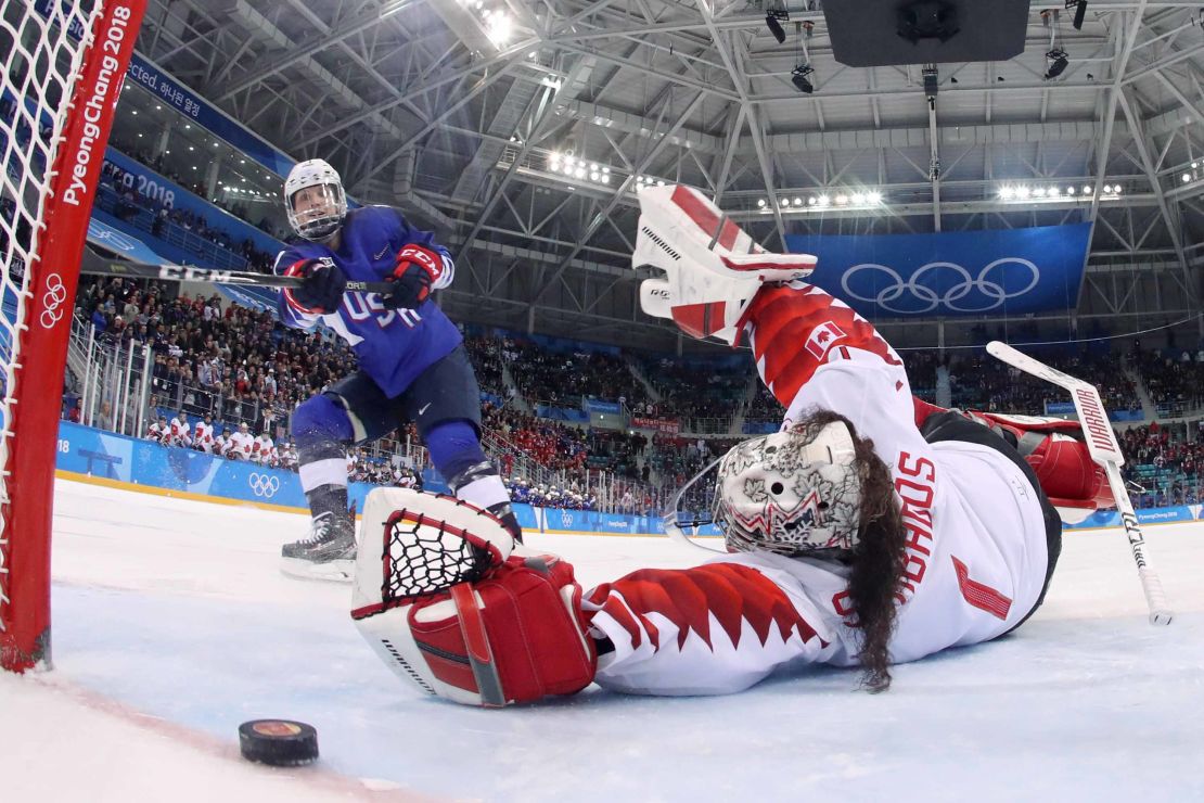 USA's Jocelyne Lamoureux-Davidson (L) scores on Canada's Shannon Szabados during the penalty-shot shootout in the women's gold medal ice hockey match.